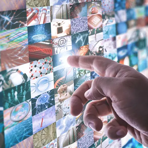 Finger touching screen displaying lots of media