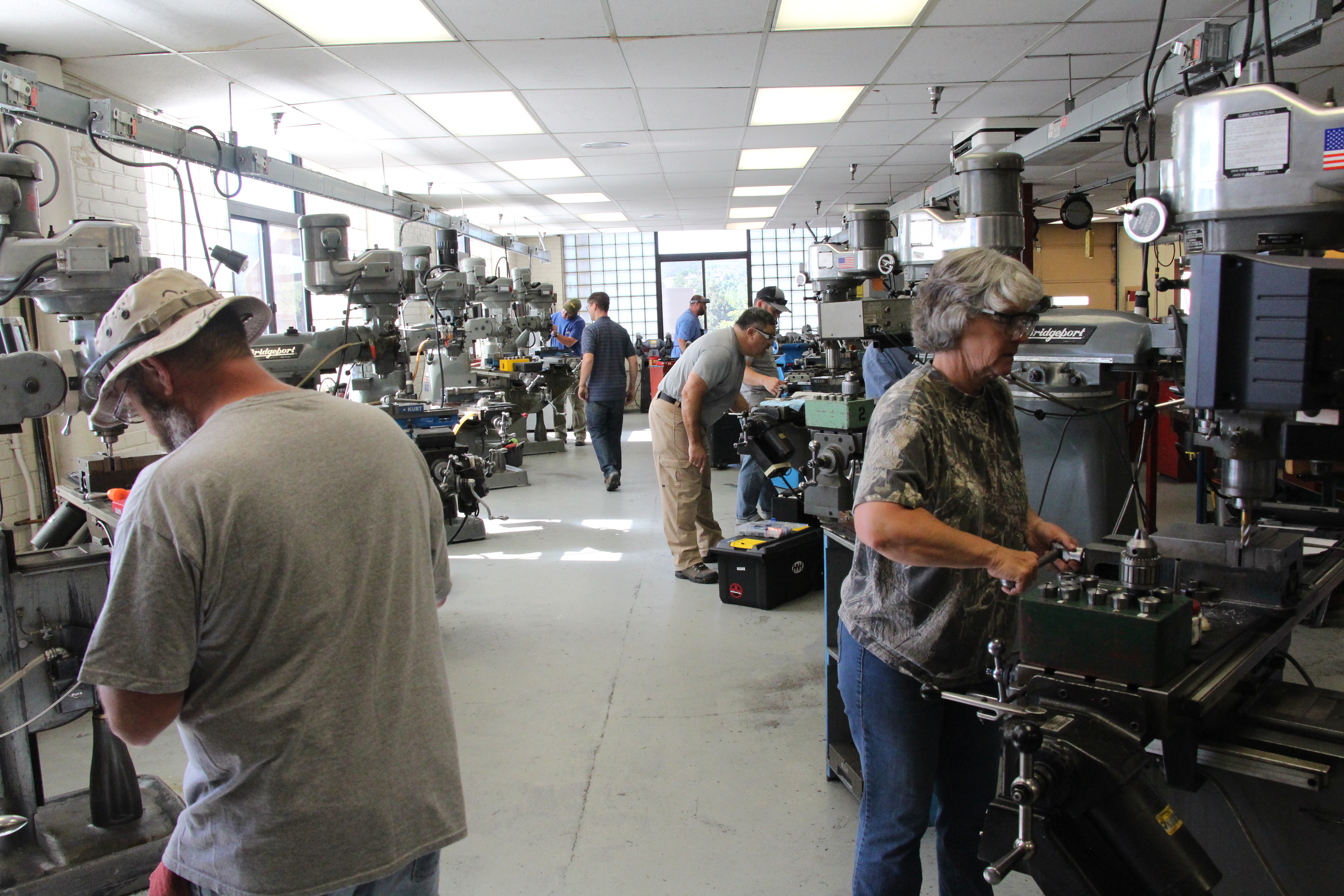 Gunsmithing lab with students working on machines.