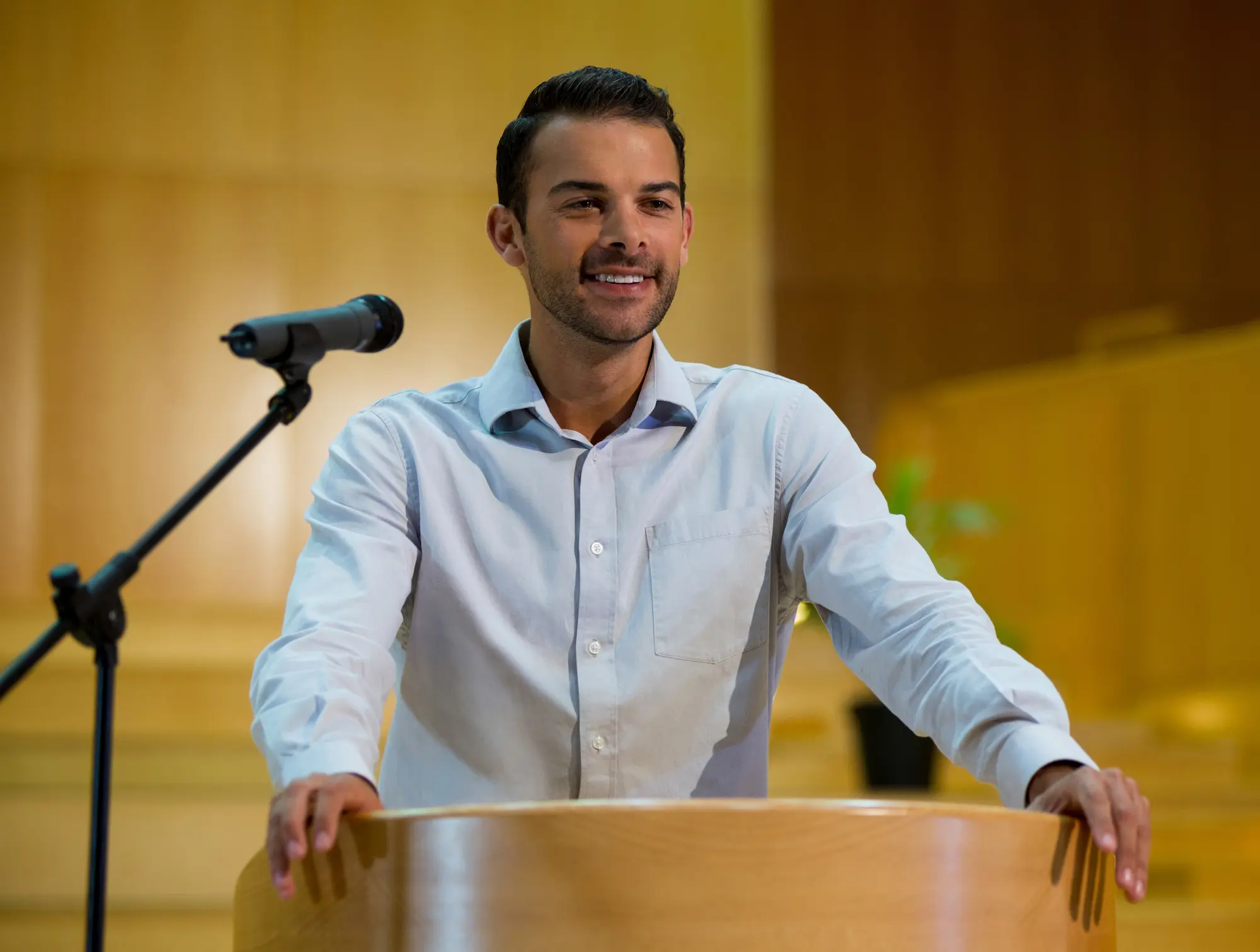 Man giving speech at podium with microphone